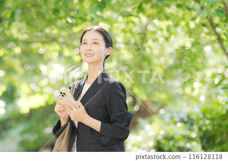 A woman with a suit with a smartphone 116128118