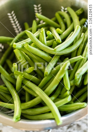 Watch as fresh green beans are beautifully roasted to perfection on a baking sheet with a silicone mat, adding a burst of flavor to your meal. Watch as fresh green beans are beautifully roasted to perfection on a baking sheet with a silicone mat, adding a burst of flavor to your meal. 116128435