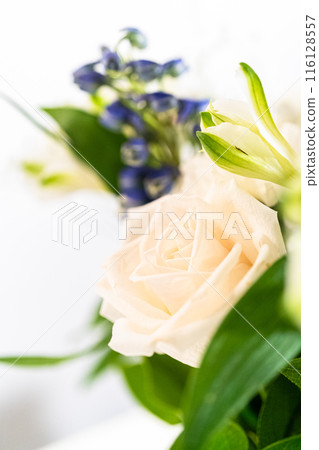 A stunning bouquet featuring fresh white roses and assorted flowers gracefully arranged in a vase, exuding timeless beauty. A stunning bouquet featuring fresh white roses and assorted flowers gracefully arranged in a vase, exuding timeless beauty. 116128557