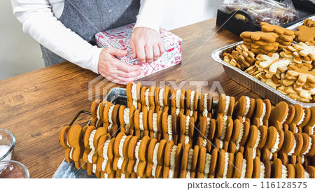 Lovingly homemade gingerbread and sugar cookies, half-dipped in rich chocolate, nestled in decorative Christmas tin boxes perfect for seasonal gifting. Lovingly homemade gingerbread and sugar cookies, half-dipped in rich chocolate, nestled in decorative Christmas tin boxes perfect for seasonal gifting. 116128575