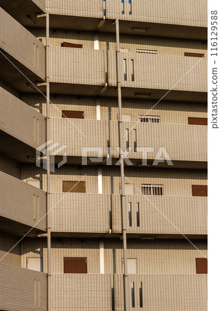 Apartment building bathed in the sunset 116129588