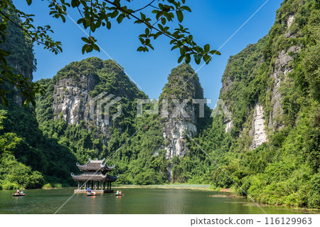Vietnam Hanoi: A floating temple on a boat tour of Ninh Binh, a river valley in a rowboat 116129963