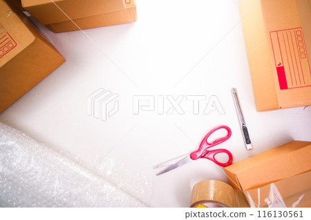 Cardboard boxes and product packaging equipment on white background with copy space for text , top view 116130561