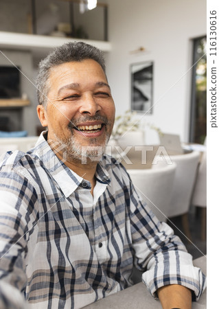 A senior biracial male radiates joy in a home setting 116130616