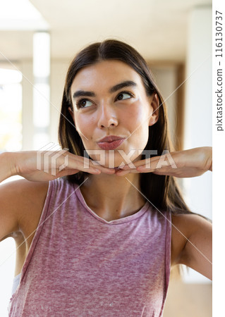 A young Caucasian brunette woman poses playfully at home A young Caucasian brunette woman poses playfully at home 116130737
