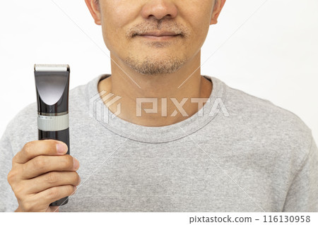 Man holding a shaver on white background 116130958