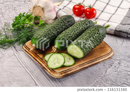 Raw green cucumbers with slices 116131380