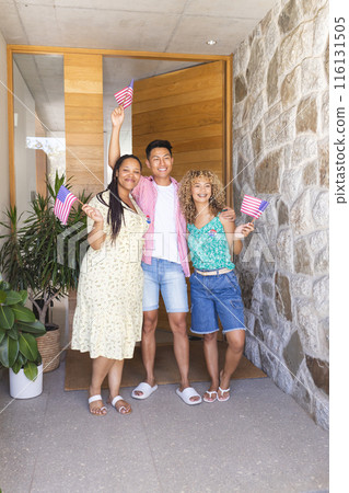 Group of friends waving American flags, standing at home entrance Group of friends waving American flags, standing at home entrance 116131505
