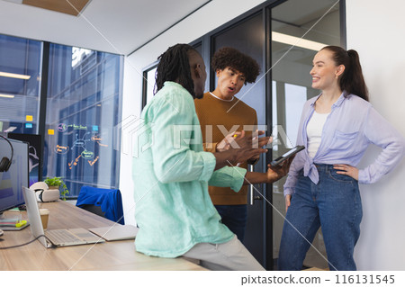 Diverse group of colleagues discussing in office, African American man holding tablet 116131545