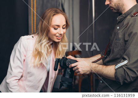 young handsome man and a positive woman choosing the best pictures young handsome man and a positive woman choosing the best pictures 116131959