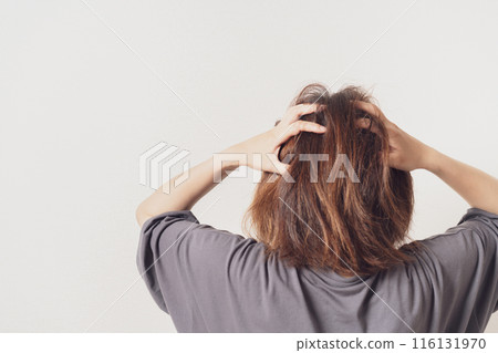 Back view of a woman holding her head 116131970