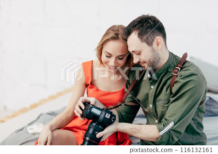 young couple checking good photos young couple checking good photos 116132161