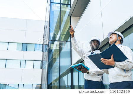 Group of multinational engineers inspecting a building 116132369