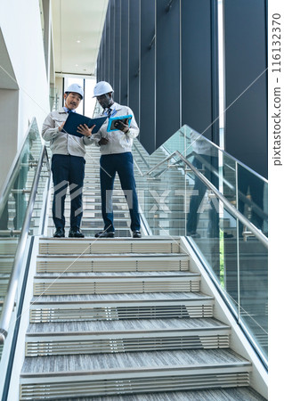Group of multinational engineers having a conversation in a facility Group of multinational engineers having a conversation in a facility 116132370