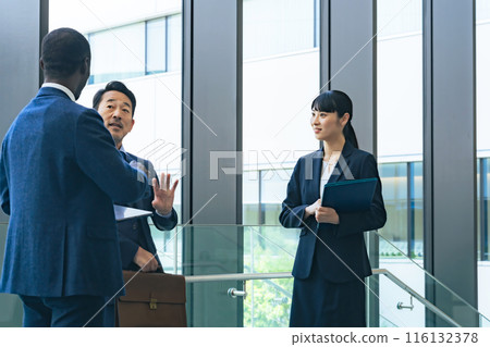 Group of multinational business people having a conversation in a lobby Group of multinational business people having a conversation in a lobby 116132378