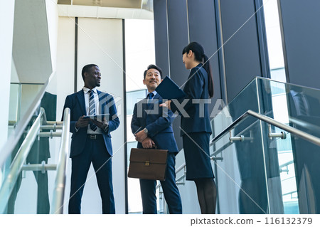 Group of multinational business people having a conversation in a lobby 116132379