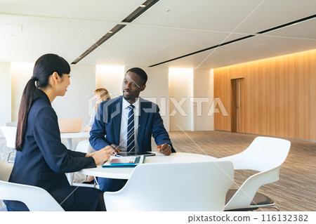 Group of multinational business people having a conversation in a lobby Group of multinational business people having a conversation in a lobby 116132382