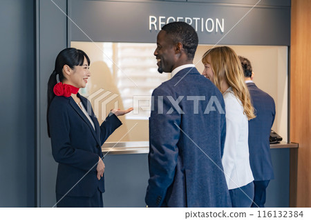 Female staff serving foreign guests at the reception Female staff serving foreign guests at the reception 116132384