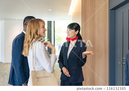 Female staff serving foreign guests at the reception Female staff serving foreign guests at the reception 116132385