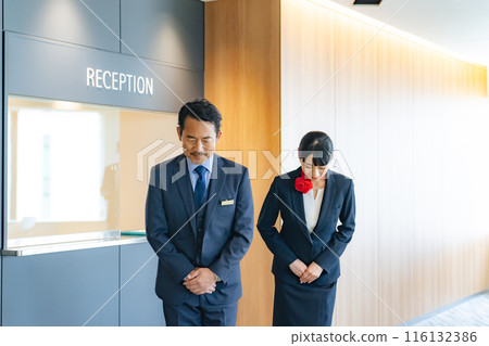 Hotel front desk staff bowing Hotel front desk staff bowing 116132386