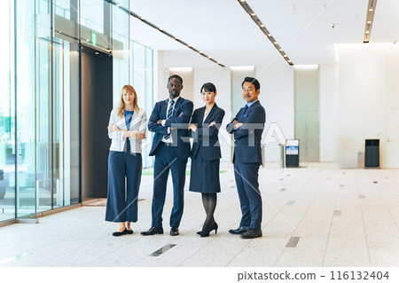 A group of multinational business people standing in a lobby 116132404