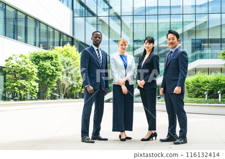 A group of multinational business people standing in front of an office building 116132414