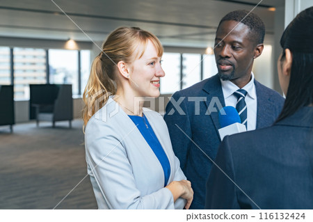 Foreign couple being interviewed 116132424