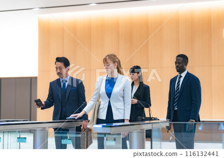Group of multinational business people passing through a security gate 116132441