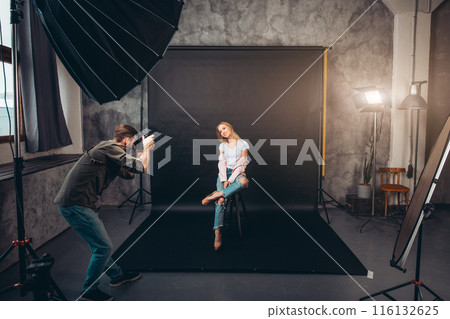 pleasant charming girl sitting with crossed legs pleasant charming girl sitting with crossed legs 116132625