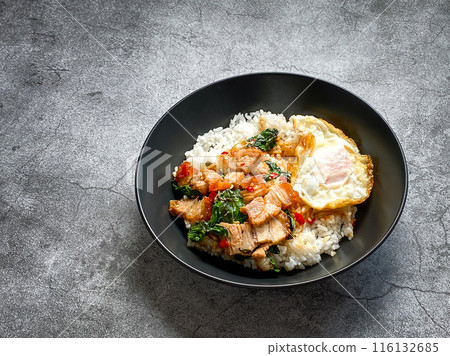 Rice topped with crispy pork belly with Thai basil and fried egg Rice topped with crispy pork belly with Thai basil and fried egg 116132685