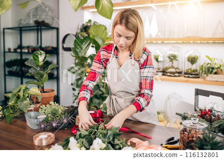 pretty young blond female making fashion modern bouquet of different flowers 116132801