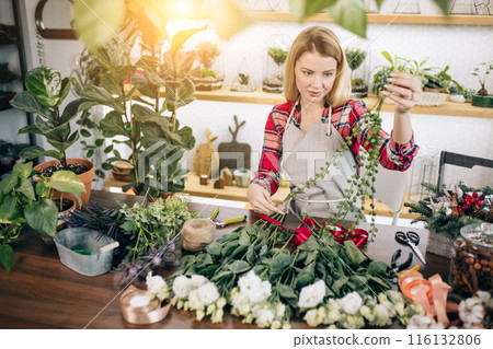 Gardening. Young caucasian florist woman working at garden 116132806