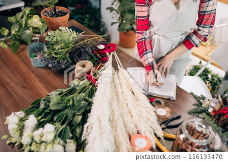 top view on florist woman writing in her notebook 116133470