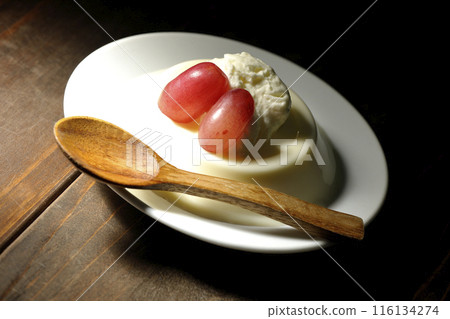 Panna cotta with cream and grapes 116134274