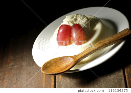 Panna cotta with cream and grapes 116134275