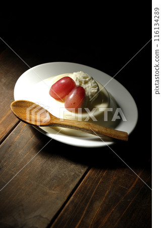 Panna cotta with cream and grapes 116134289