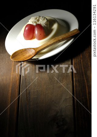 Panna cotta with cream and grapes 116134291