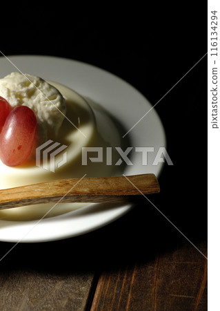 Panna cotta with cream and grapes 116134294
