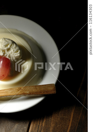 Panna cotta with cream and grapes 116134303