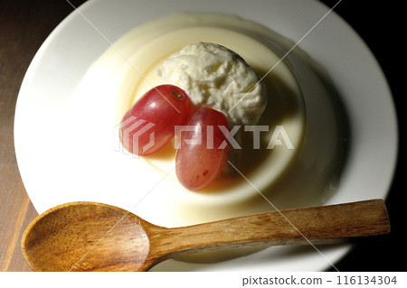 Panna cotta with cream and grapes 116134304