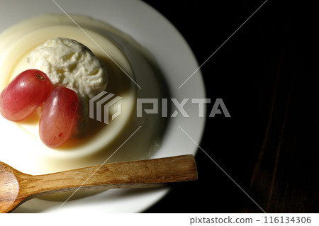 Panna cotta with cream and grapes 116134306