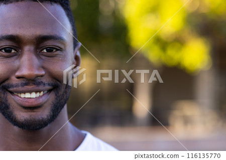 African American young male athlete smiling, standing on field outdoors, copy space African American young male athlete smiling, standing on field outdoors, copy space 116135770