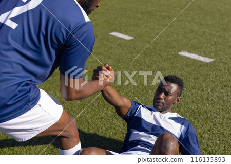 Two African American young male athletes are training on field outdoors Two African American young male athletes are training on field outdoors 116135893