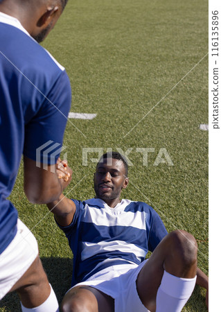 Two African American young male athletes are training on field outdoors, copy space 116135896