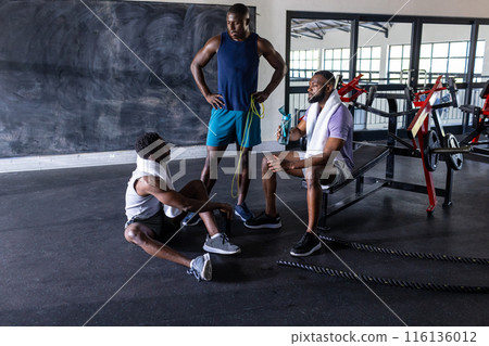 Three African American young male athletes, a group of fitness models training in gym, copy space 116136012