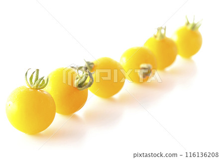Yellow cherry tomatoes photographed on a white background Yellow cherry tomatoes photographed on a white background 116136208