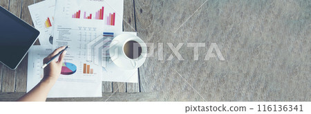 Banner woman working office desk reading financial report finance chart graph on table. Wide tax audit woman hands working paperwork office. Banner Businesswoman Audit financial with copy space Banner woman working office desk reading financial report finance chart graph on table. Wide tax audit woman hands working paperwork office. Banner Businesswoman Audit financial with copy space 116136341