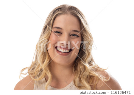 Smiling young plus-size Caucasian female model, with subtle makeup on a white background Smiling young plus-size Caucasian female model, with subtle makeup on a white background 116136471