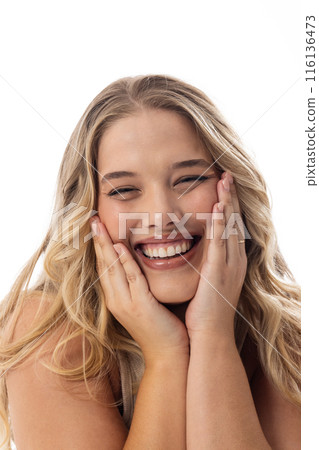 A young Caucasian plus size model laughs, touching her face on white background A young Caucasian plus size model laughs, touching her face on white background 116136473