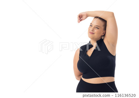 Caucasian young female plus size model on white background poses confidently, copy space Caucasian young female plus size model on white background poses confidently, copy space 116136520